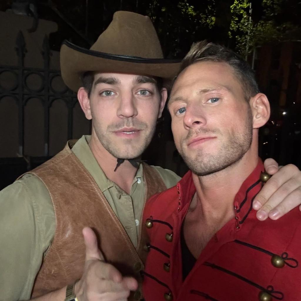 Matt Rogers in a cowboy hat and vest with Fraser Olender in a red jacket.