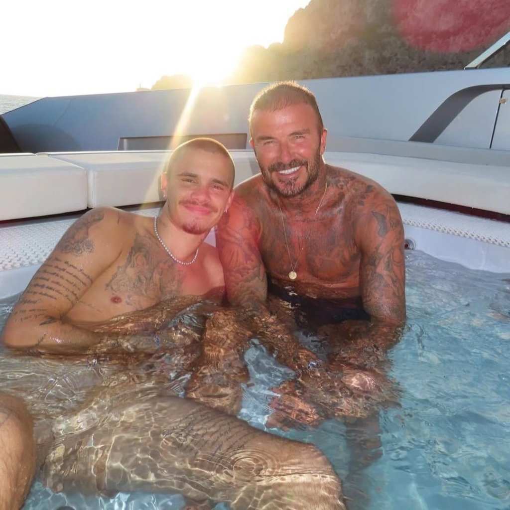 David Beckham and Romeo Beckham in a hot tub on a boat.