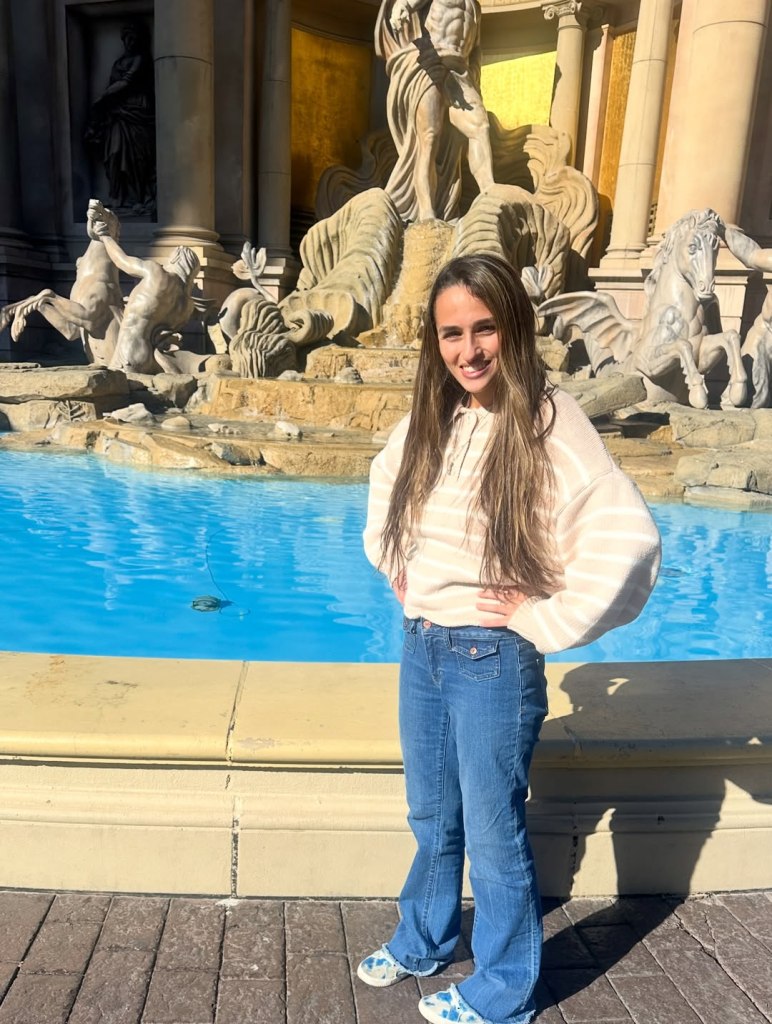 Jazz Jennings smiling in front of a fountain.