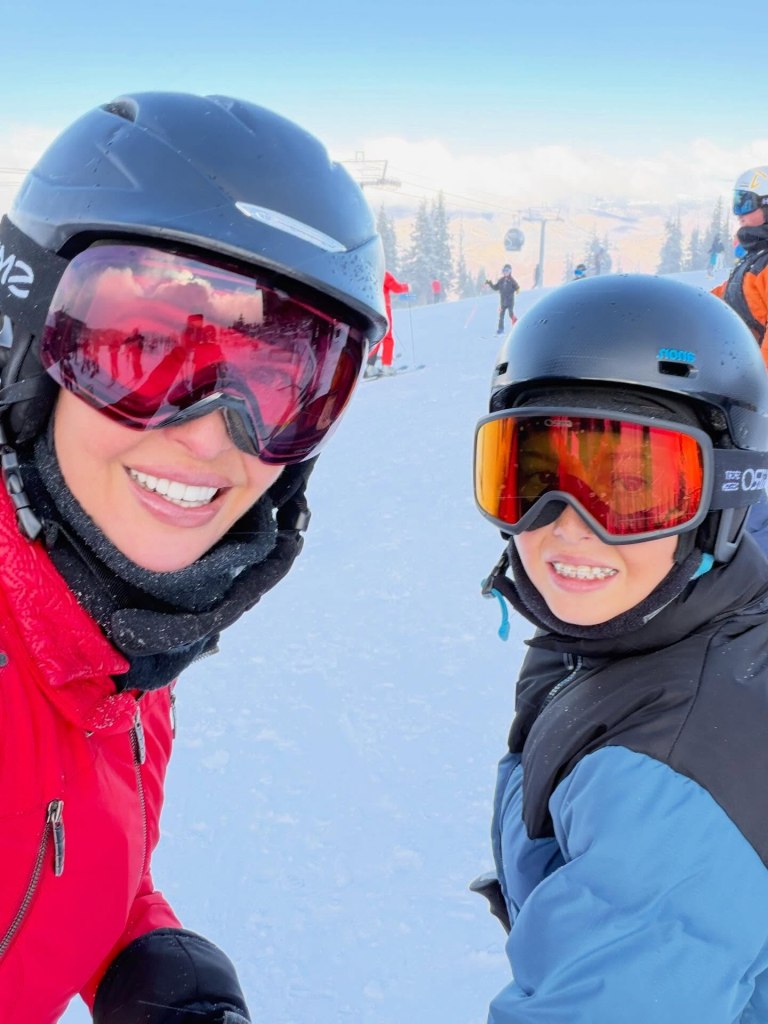 Ivanka Trump and her son skiing on a snowy mountain.