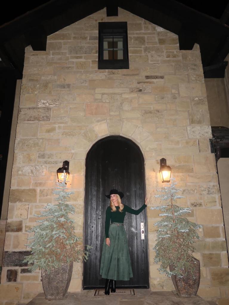 Ivanka Trump posing in front of an arched doorway on a stone building.