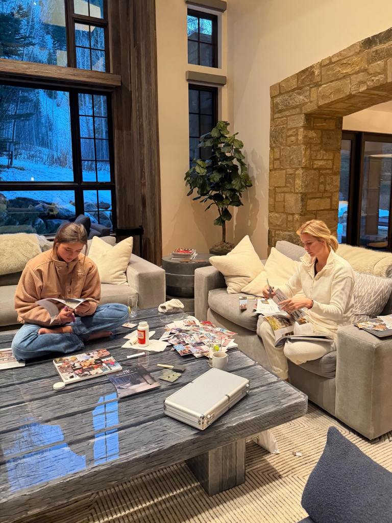 Ivanka Trump and her daughter making collages in a living room with large windows overlooking a snowy landscape.