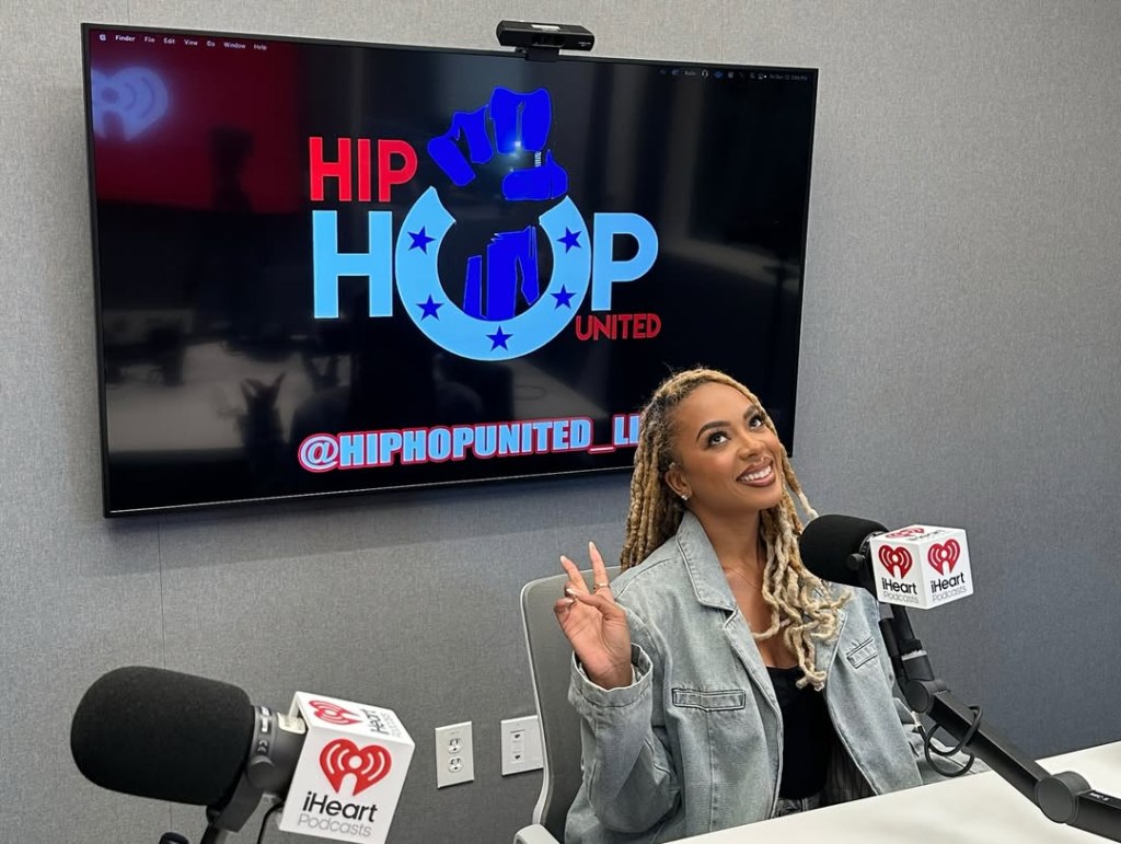 Mickey Lee in a recording studio in front of a screen displaying the 