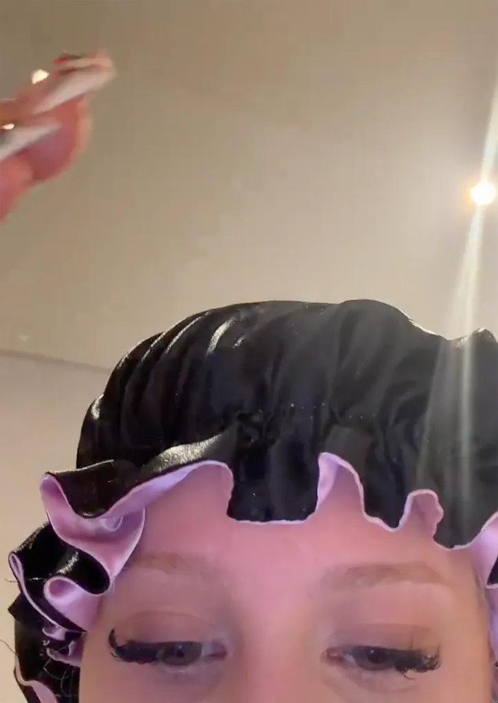 Alabama Barker in a satin hair bonnet.