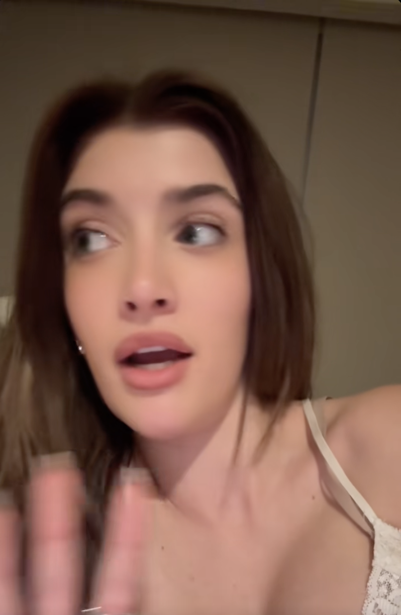 Sami Sheen in a close-up photo, looking away with an open mouth.