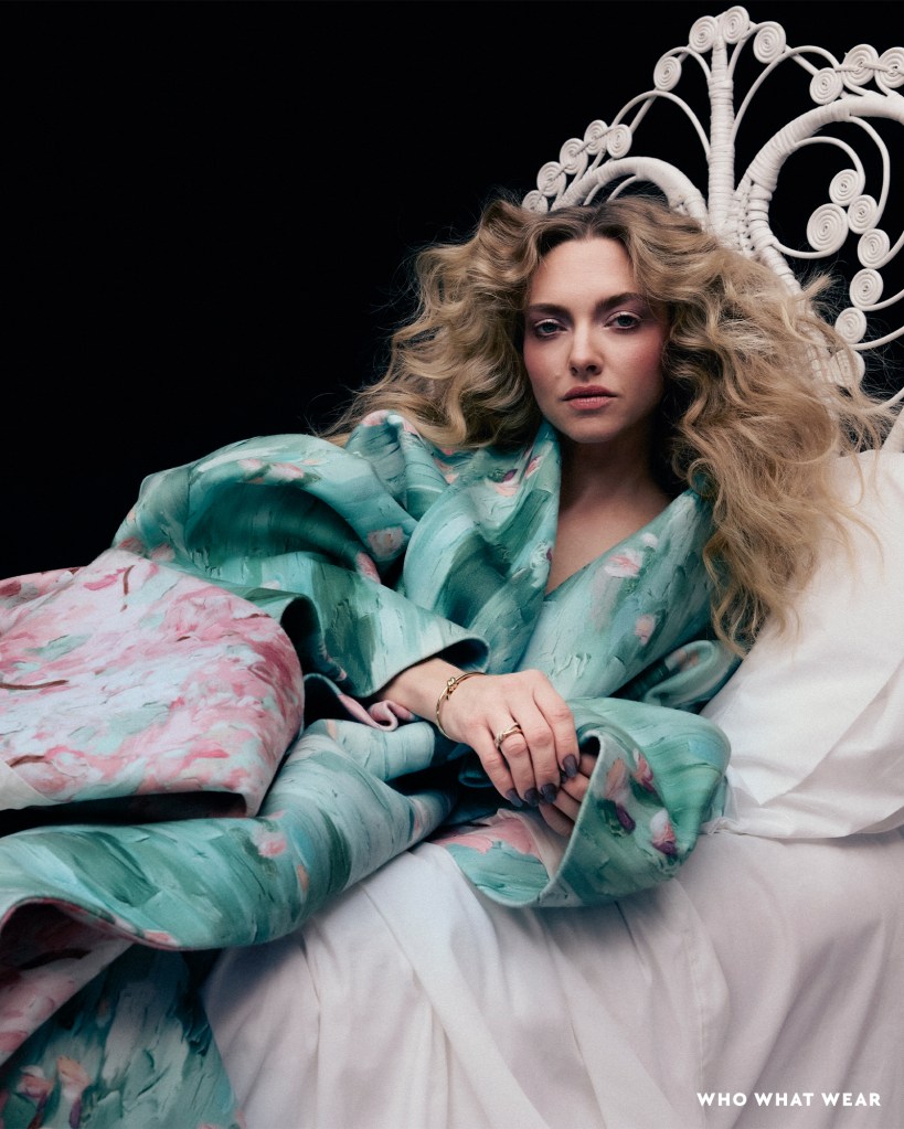 Amanda Seyfried in a colorful robe on a bed for Who What Wear's December Cover Story.