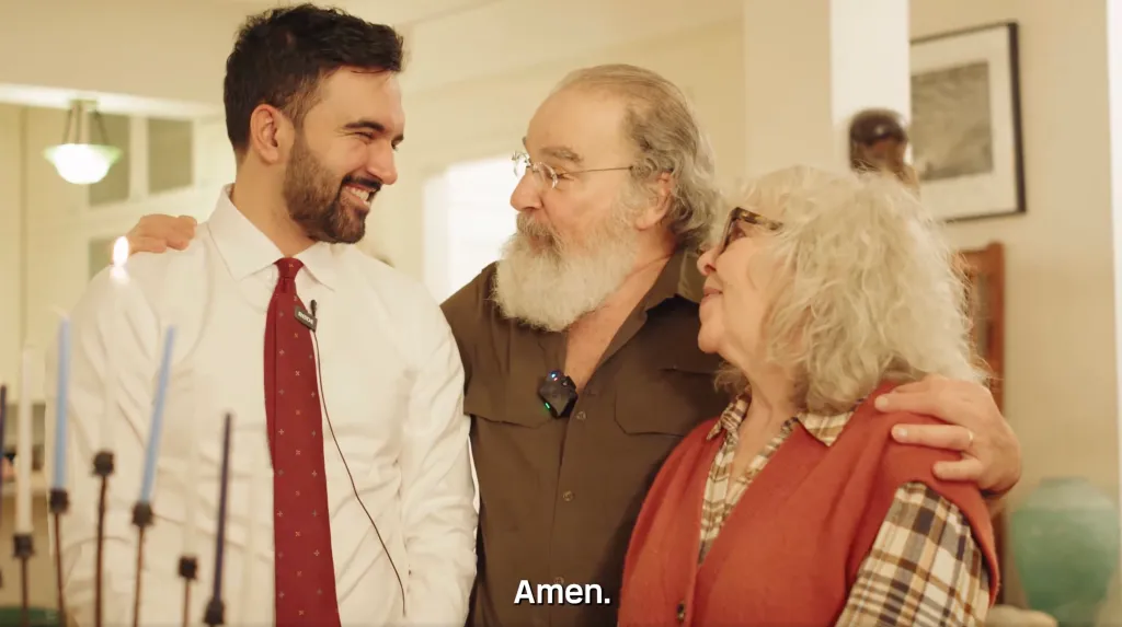 Zohran Mamdani, Mandy Patinkin, and Kathryn Grody celebrating the Festival of Lights.