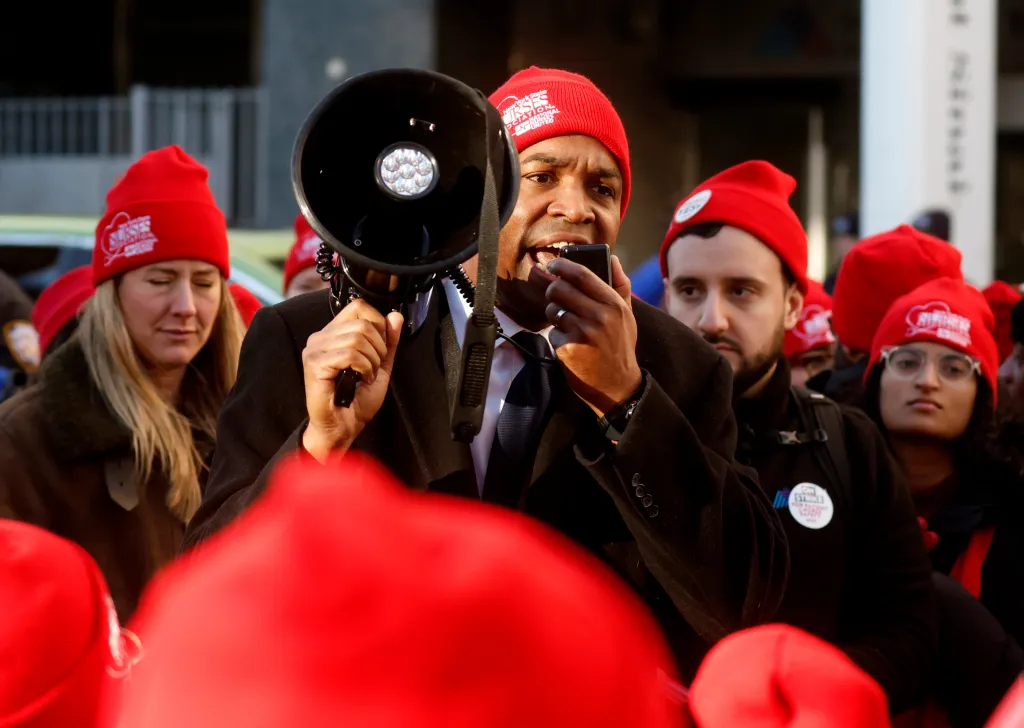 Lieutenant Governor Antonio Delgado speaking into a megaphone at a nurses' strike.