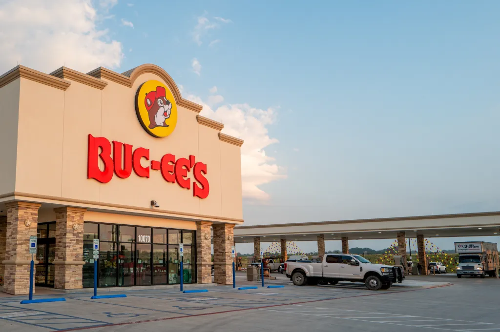 The exterior of a Buc-ee's convenience store with its red and yellow logo and a large covered gas pump area.