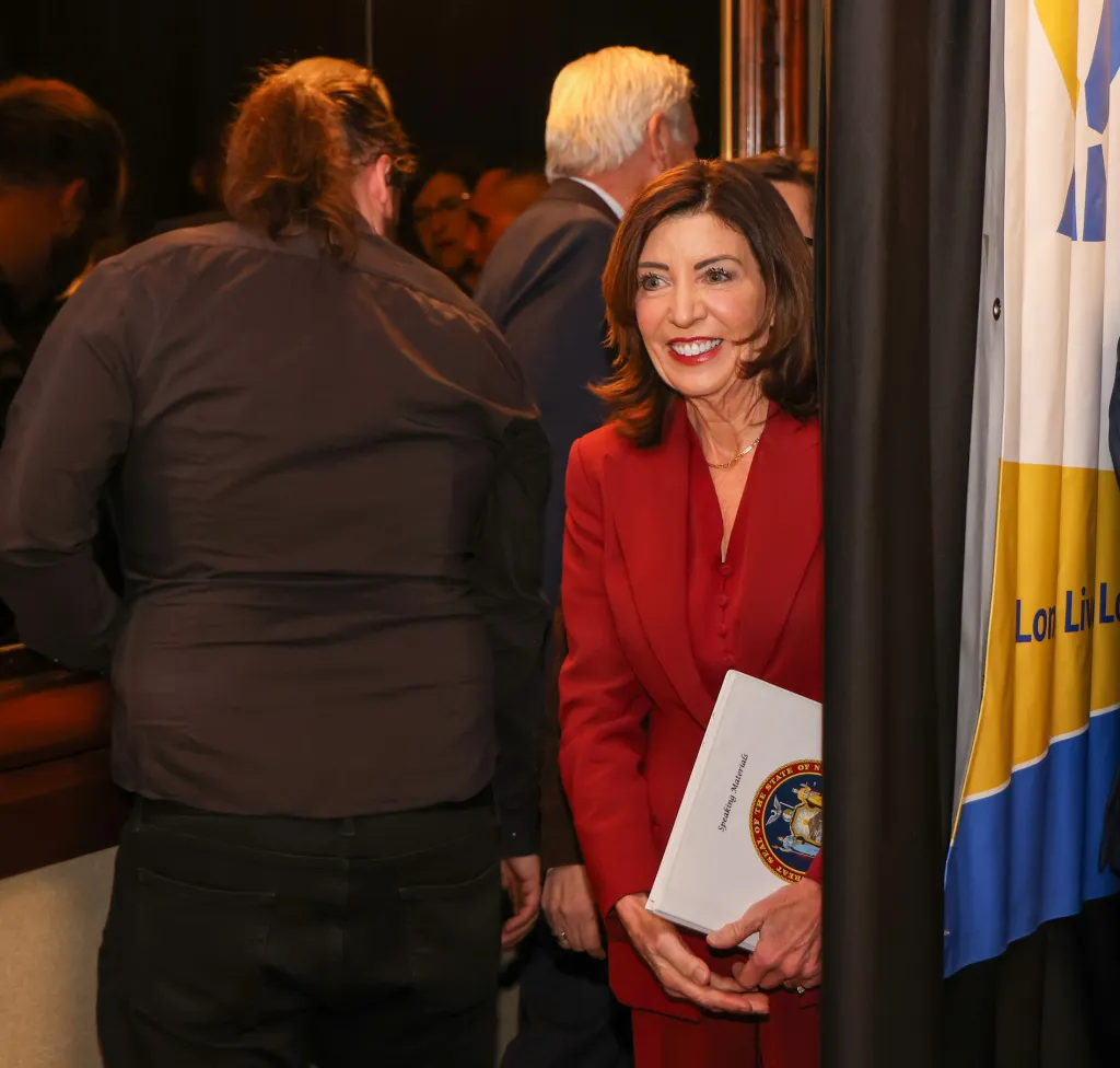 Governor Kathy Hochul smiling and holding 
