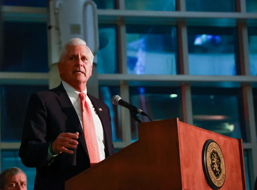 Nassau County Executive Bruce Blakeman delivering a speech at a podium.