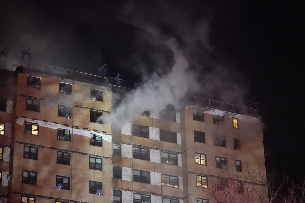 Smoke pours out of a window after a fire in the Bronx.
