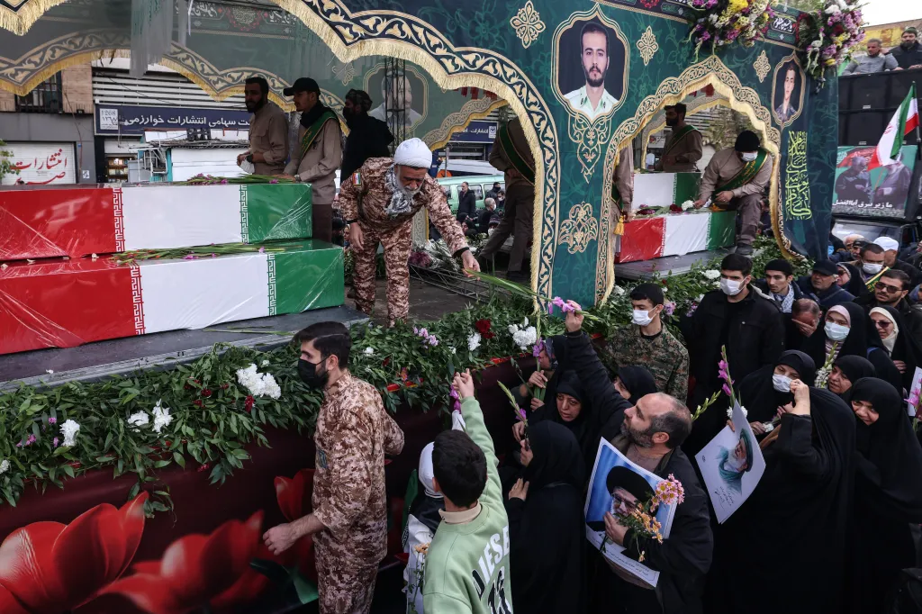 Mourners attend the funeral of security forces personnel in Tehran, with coffins draped in the Iranian flag.