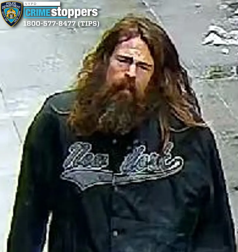 The long-haired, bearded suspect was caught in the act etching the disturbing words on the door of The Grolier Club on East 60th Street near Park Avenue around 12:15 p.m. Dec. 27, police said.