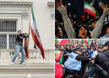 Protester scales Iranian Embassy in London, tears down regime flag, hoists pre-revolution symbol