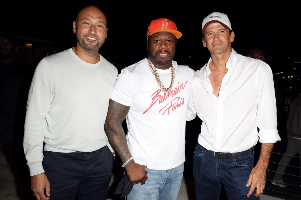 Derek Jeter, 50 Cent, and an unidentified man pose for a photo.
