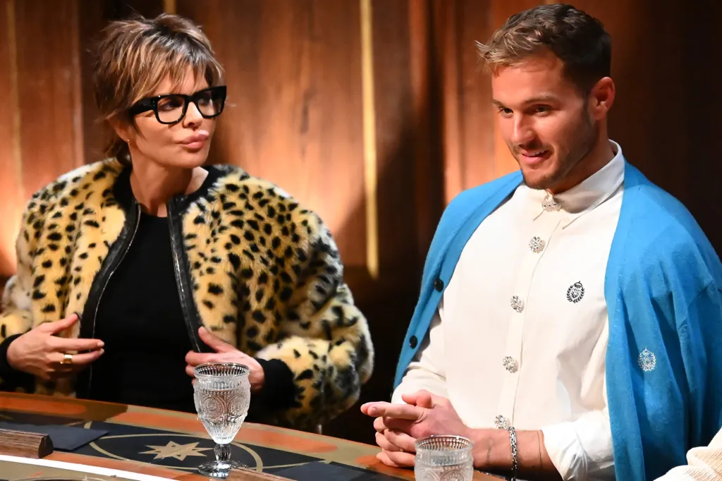 Lisa Rinna and Lukas Gage seated at a table.