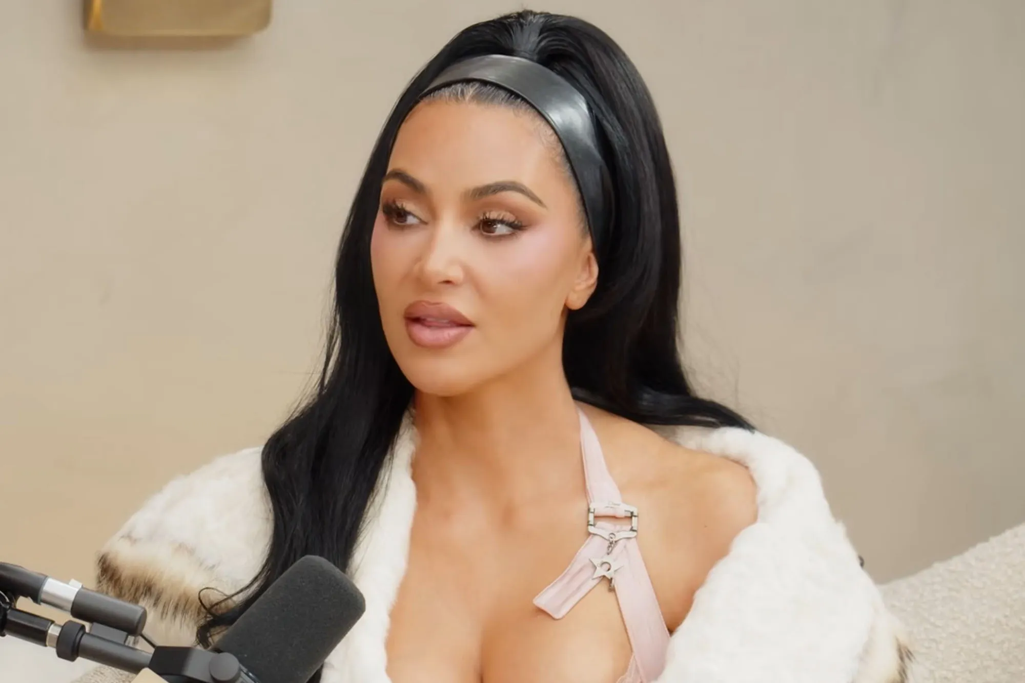 Kim Kardashian and Kris Jenner posing together, with Kim's arm around Kris's shoulder.