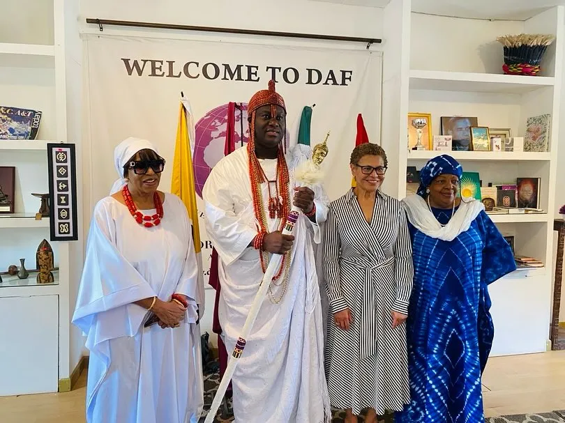 Four individuals, three women and one man, stand together, welcoming guests to DAF.