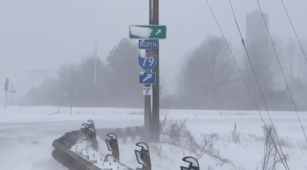 Snow-covered road sign for I-79 North with an arrow pointing right.