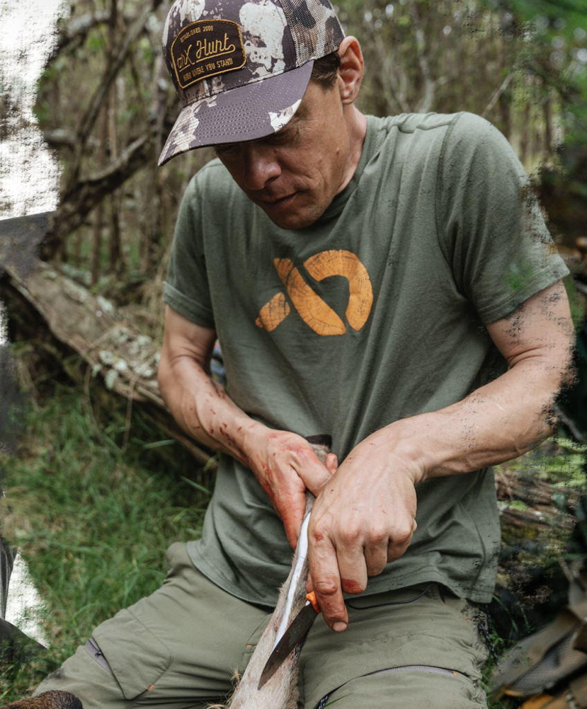 Steven Rinella skinning an animal outdoors.