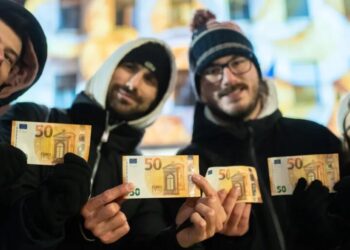 Cash machines in this former communist country issue euros for the first time after becoming the 21st member of the currency union