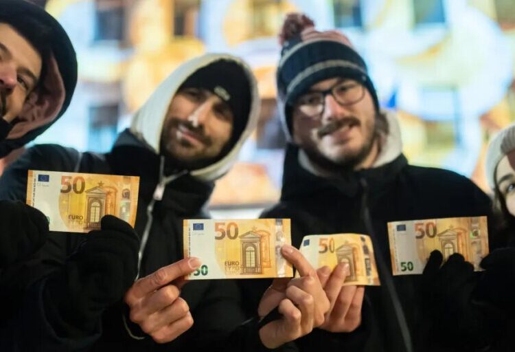 Cash machines in this former communist country issue euros for the first time after becoming the 21st member of the currency union