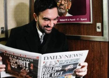 French tourists didn’t believe the young guy on the subway was New York City’s new mayor, so he held up the newspaper to prove it