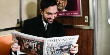 French tourists didn’t believe the young guy on the subway was New York City’s new mayor, so he held up the newspaper to prove it