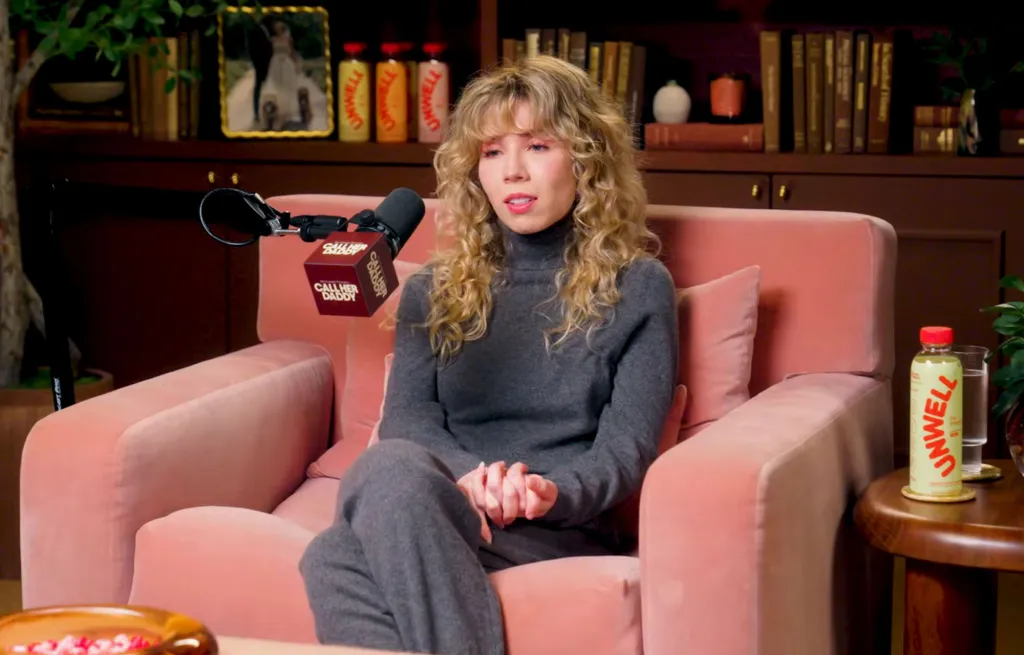 Jennette McCurdy sits on a pink couch during a