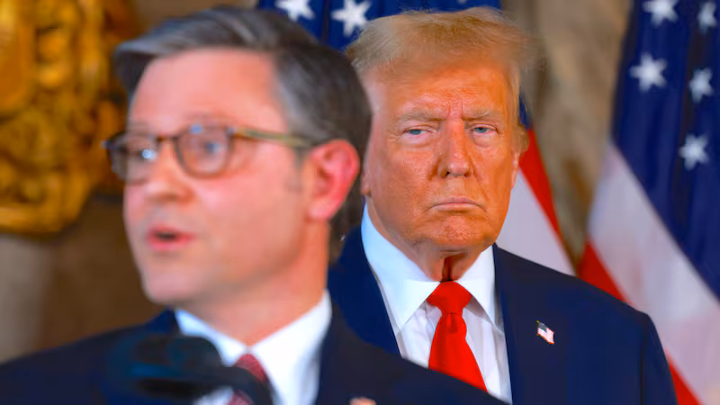 President Donald Trump listens as Mike Johnson speaks during a press conference at Mr. Trump's Mar-a-Lago estate on April 12, 2024, in Palm Beach, Florida.