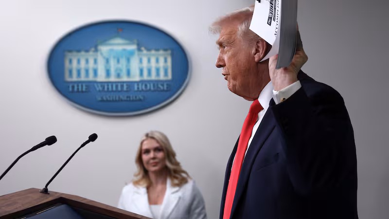 WASHINGTON, DC - JANUARY 20: U.S. President Donald Trump displays a stack of binders as he speaks to the media during a press briefing in the James S. Brady Press Briefing Room of the White House on January 20, 2026 in Washington, DC. White House Press Secretary Karoline Leavitt was joined by President Trump days after the president threatened a 10% import tax on goods from eight European countries that have rallied around Denmark amid Trump's calls for the U.S. to take control of Greenland, a semi-autonomous Danish territory. (Photo by Win McNamee/Getty Images)
