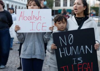 Videos show man killed by immigration agents was only holding a phone before he was shot, contradicting administration statements