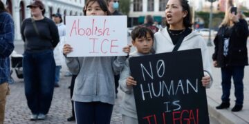 Videos show man killed by immigration agents was only holding a phone before he was shot, contradicting administration statements