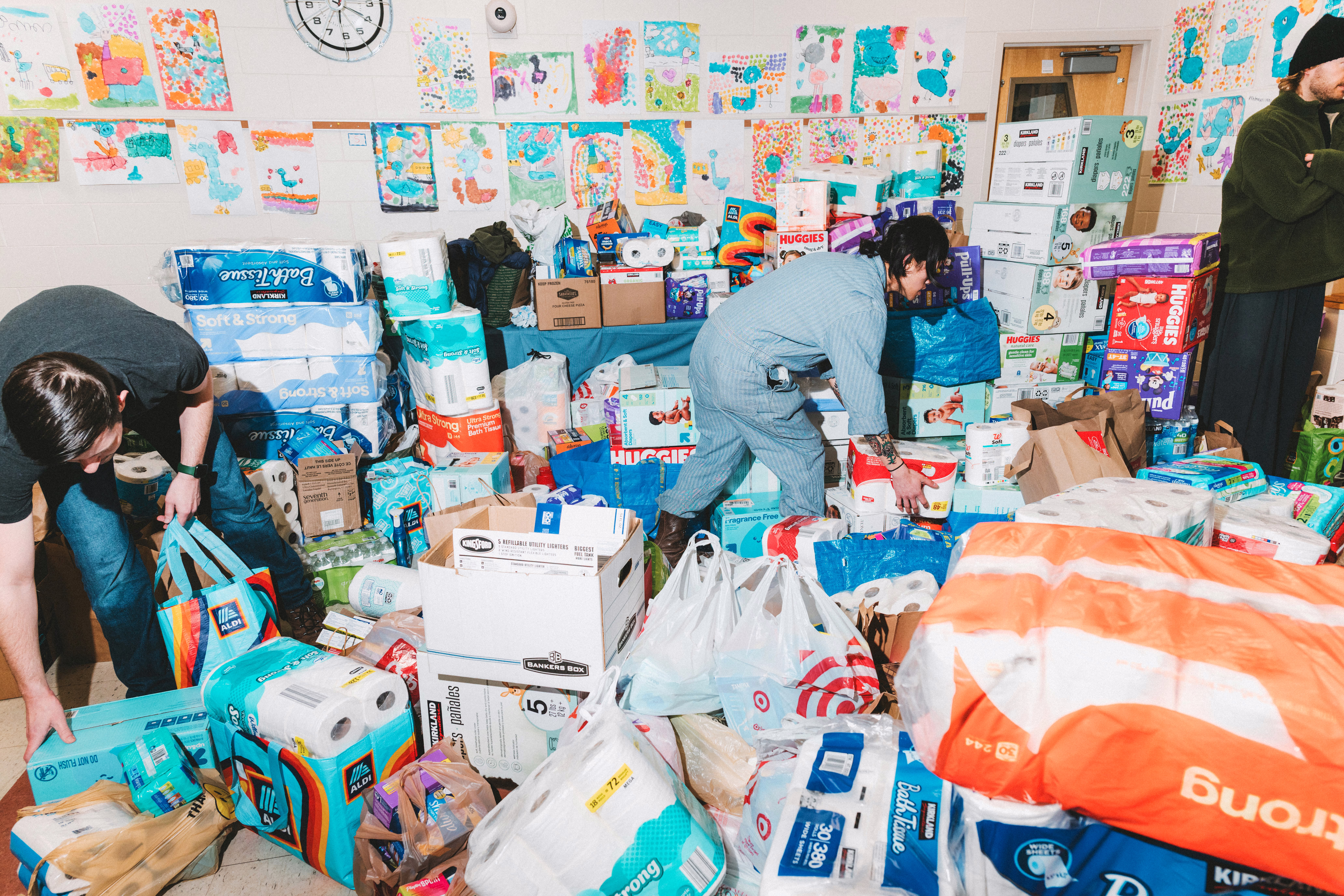 Toiletries and childcare products are collected in a room by organizers
