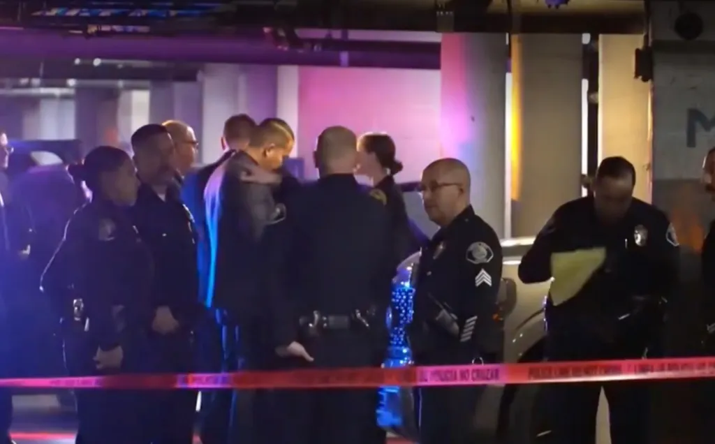 Police officers investigating a crime scene marked by red tape.