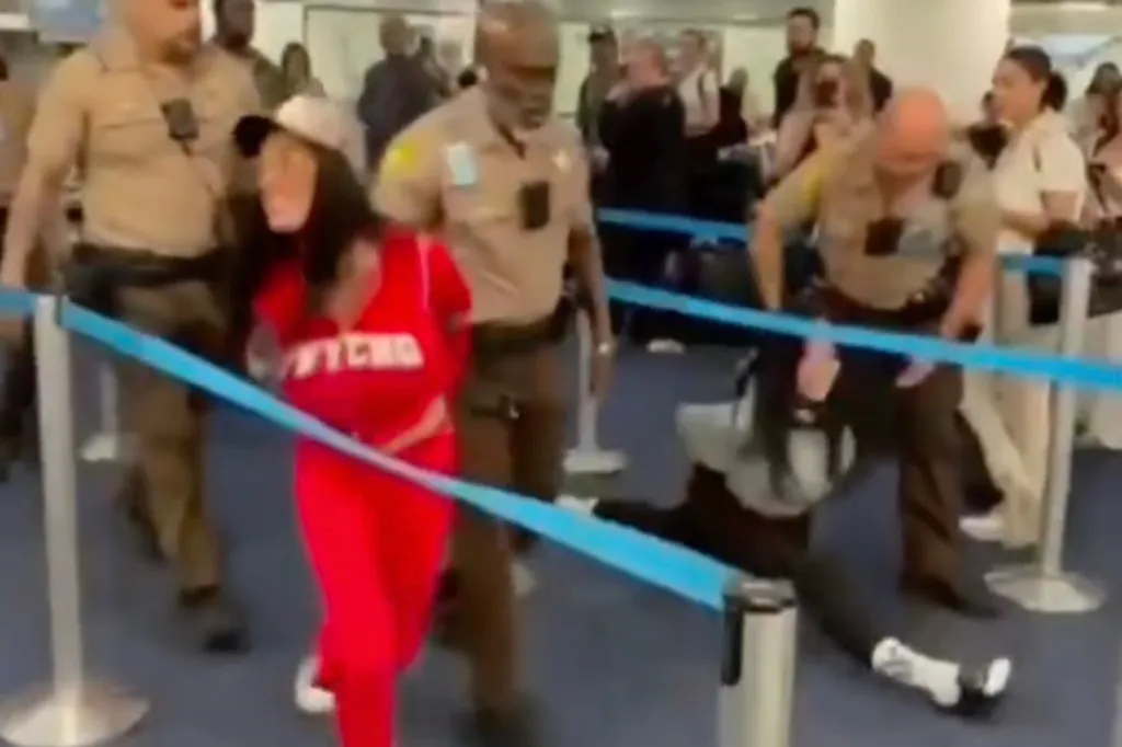 Sania Blanchard yells out as Jordan Lantry does a split during their arrest at Miami International Airport on Jan. 9, 2026.