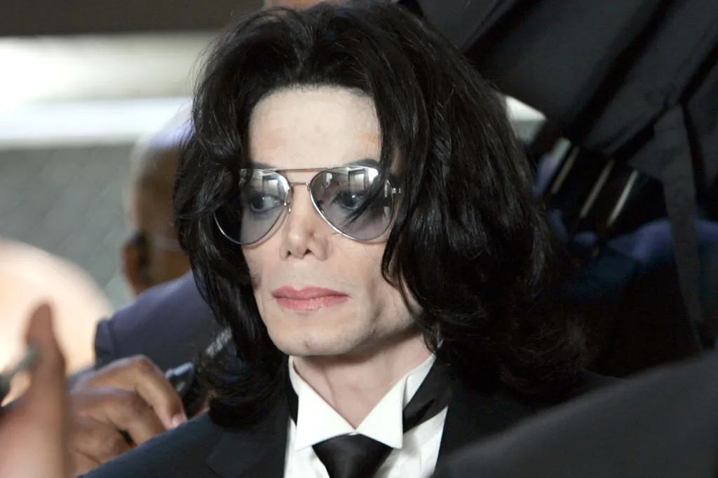 Michael Jackson in aviator sunglasses and a suit, attending court for his child molestation trial.