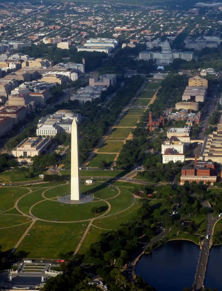 Aerial view of downtown Washington with the World War II Memorial at the bottom, the Washington Monument and National Mall at the center, and the U.S. Capitol building at the upper right.