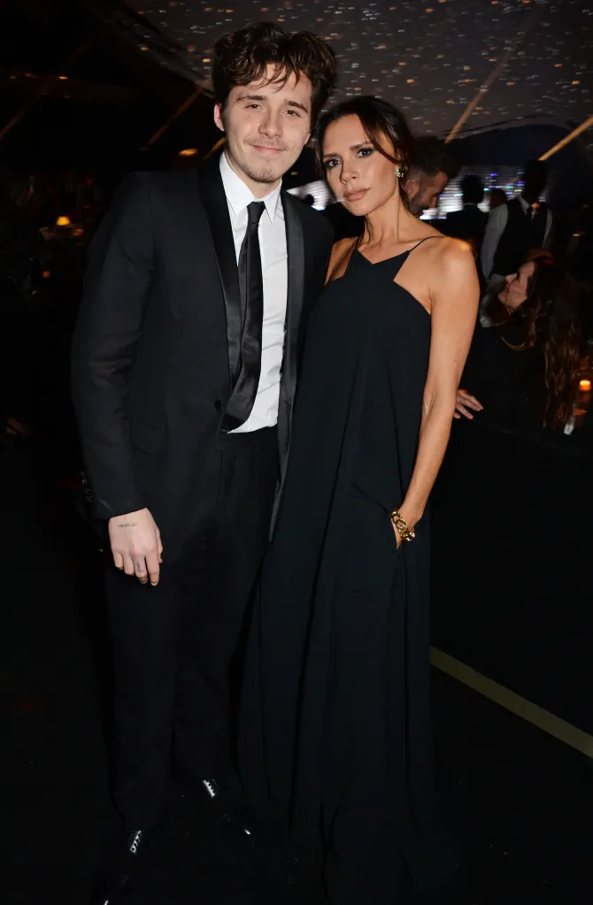 Brooklyn and Victoria Beckham posing for a photo.