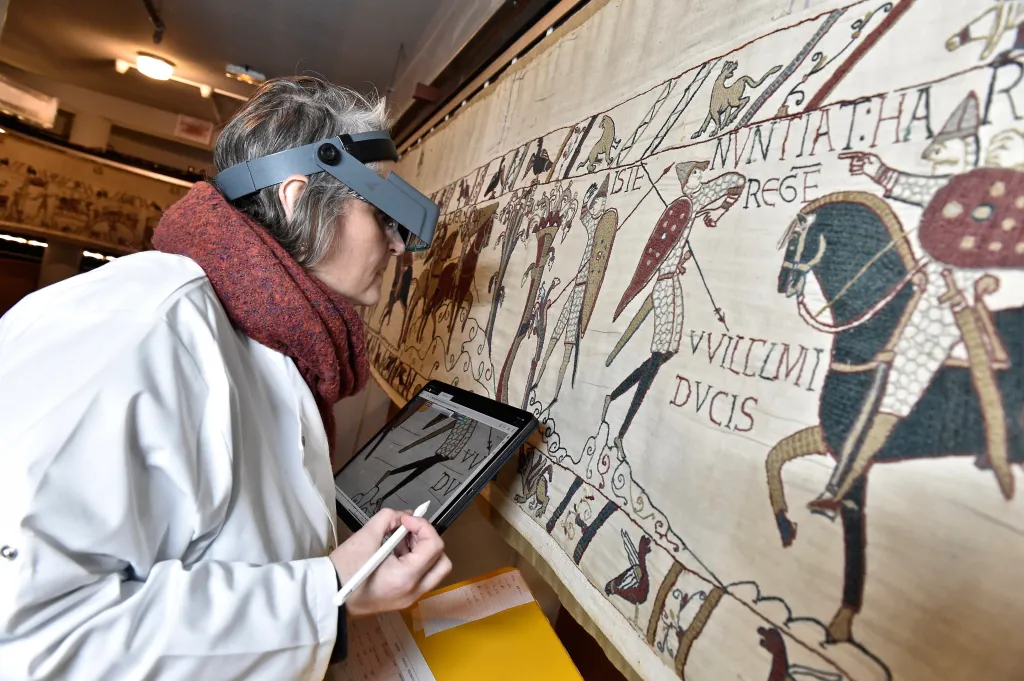 a technician inspecting the tapestry in Bayeux, Normandy, in Jan. 8 2020.
