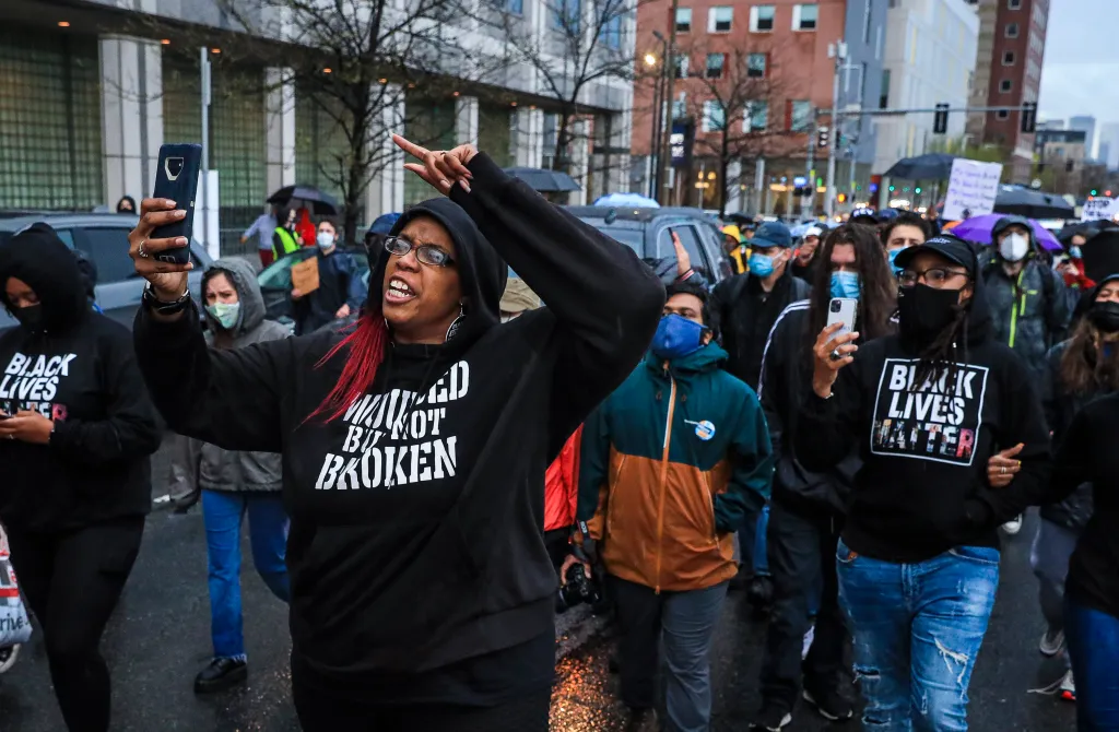 Monica Cannon-Grant leads a protest through Boston's Nubian Square to Boston Police headquarters on April 21, 2021.