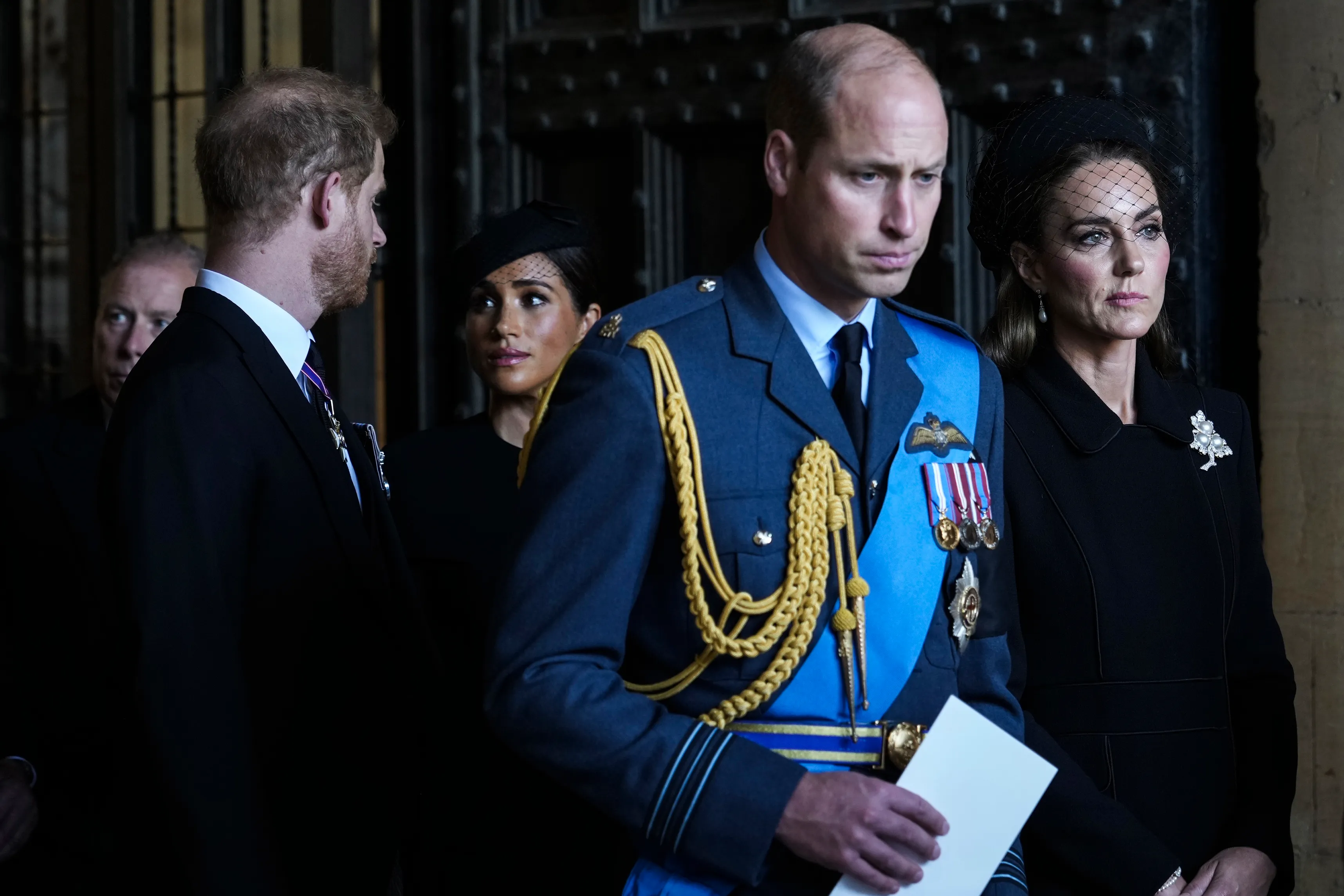 Prince William, Prince Harry, Meghan Markle, and Kate Middleton leave after escorting the coffin of Queen Elizabeth II to Westminster Hall.