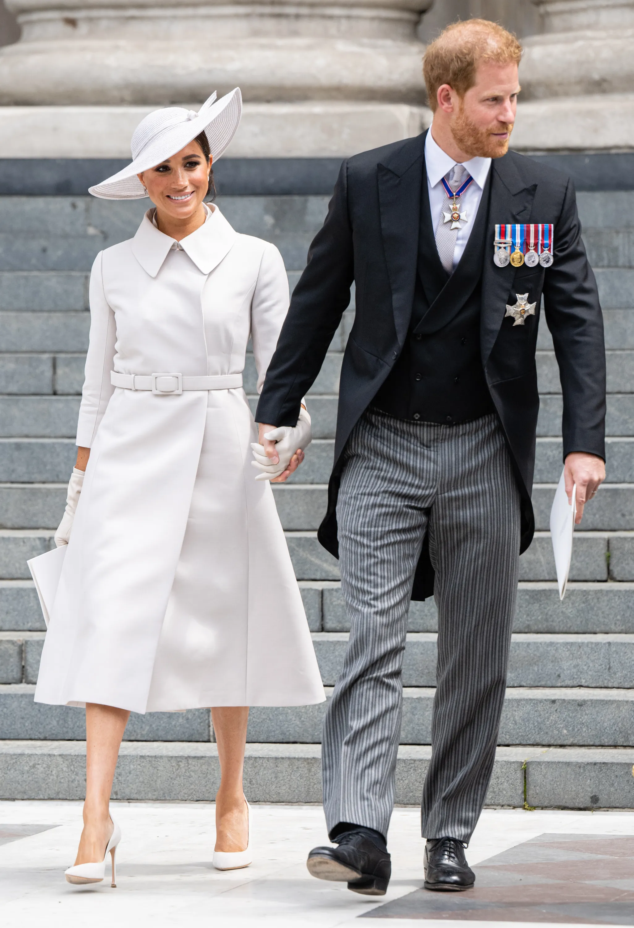 Meghan Markle and Prince Harry holding hands at the National Service of Thanksgiving in 2022