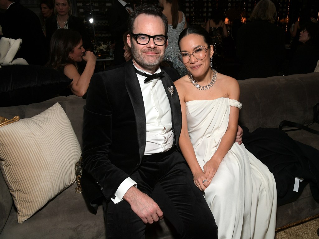 Bill Hader and Ali Wong seated on a couch at the Golden Globe After Party.
