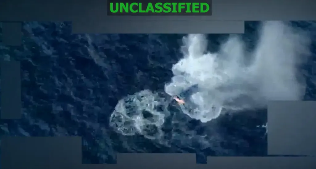 Aerial view of an explosion on a boat in the ocean.