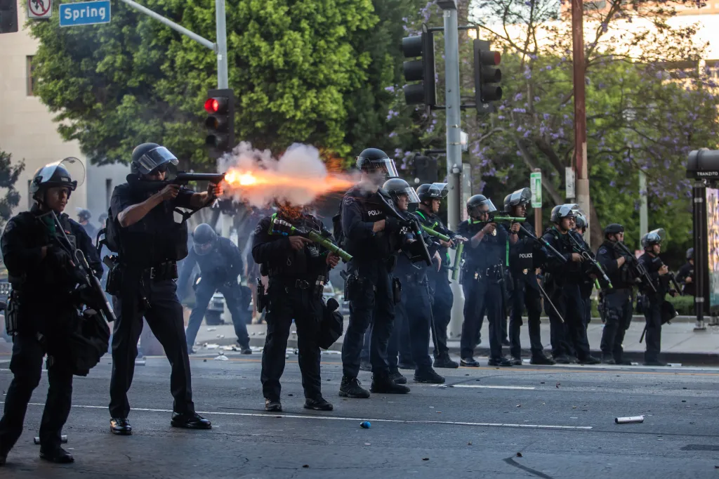 Los Angeles Police Department (LAPD) officers shoot rubber bullets at protesters in front of City Hall.