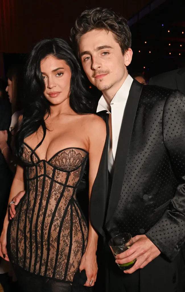 Kylie Jenner in a black lace gown and Timothée Chalamet in a black textured suit at the 2025 Vanity Fair Oscar Party.