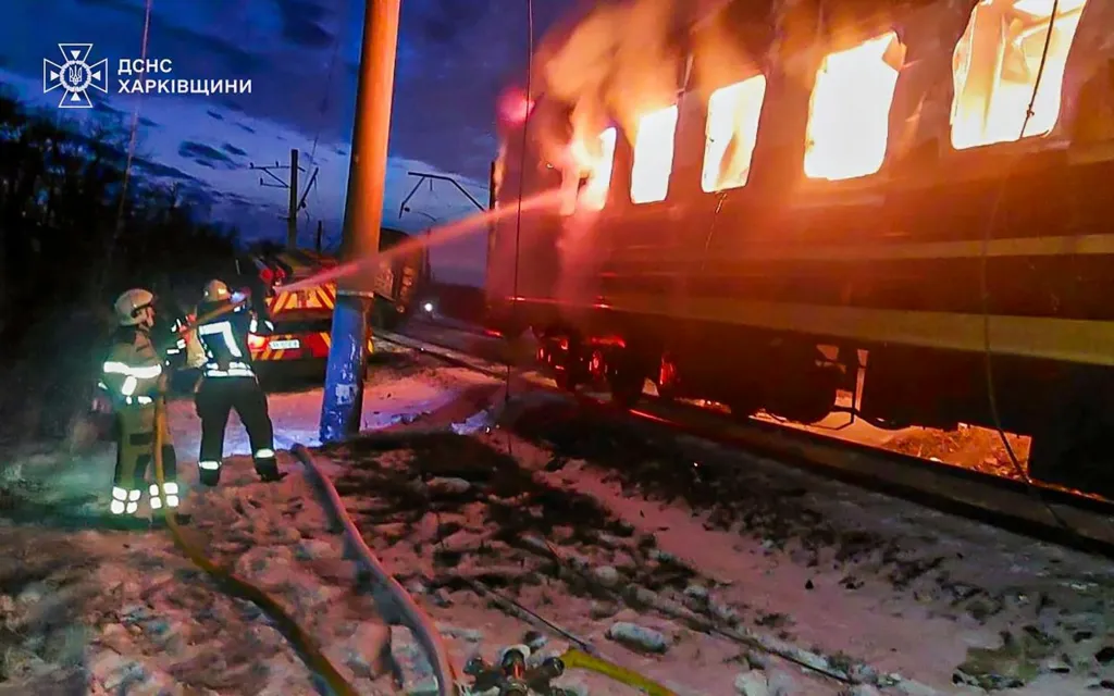 Ukrainian firefighters working to extinguish a blaze on a passenger train after it was hit by a Russian drone in the city of Izyum on Jan. 27, 2026.