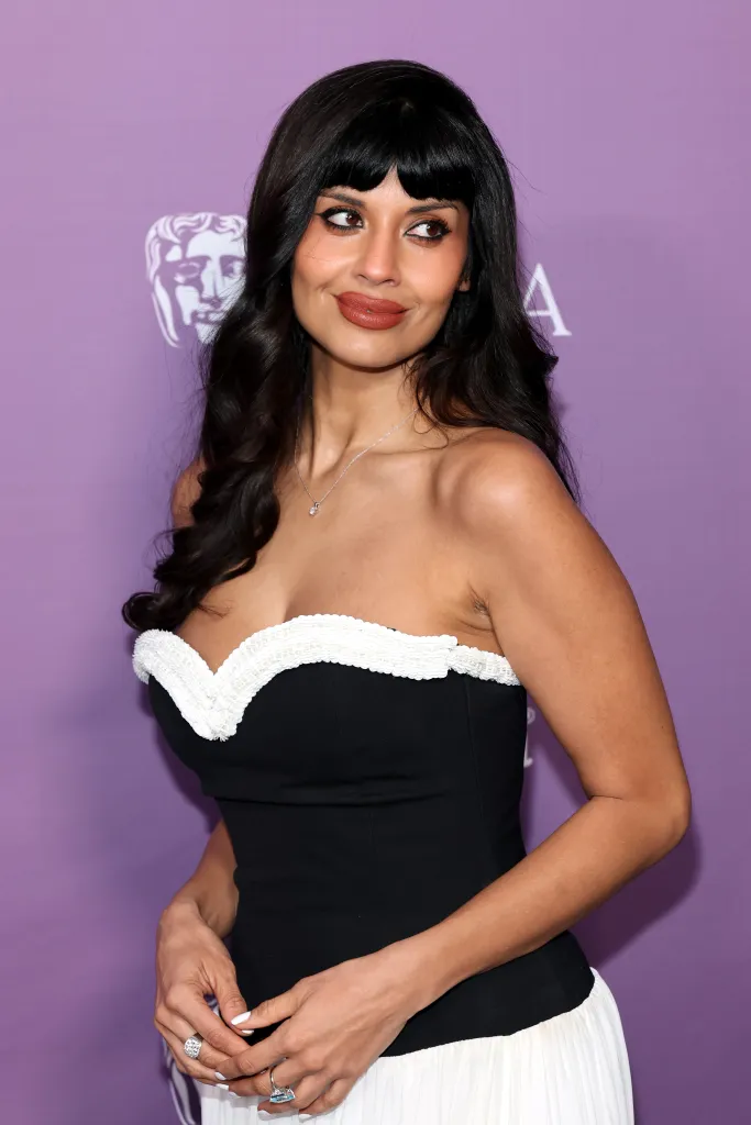 Jameela Jamil in a black and white strapless gown.